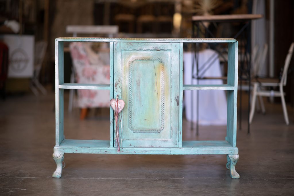 Old turquoise wooden cabinet with peeling, worn paint before its chalk paint makeover